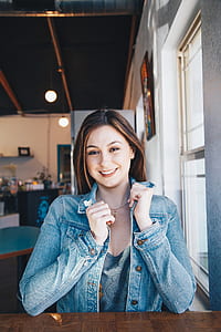 portrait photography of woman holding collar of her denim jacket thumbnail