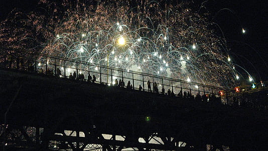 people on bridge watching firework display thumbnail