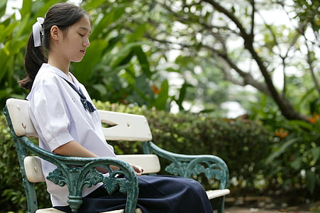 woman sitting on white bench thumbnail