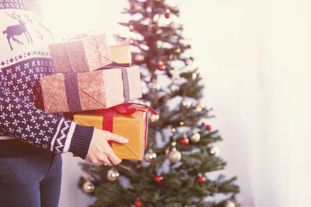 Woman’s hands hold christmas gift boxes. Merry Christmas thumbnail