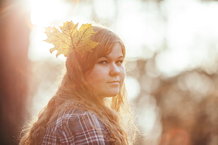 Woman Wearing White Red and Gray Plaid Shirt With Leaf Headdress thumbnail