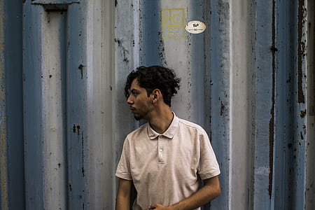 man lean on gray metal fence thumbnail
