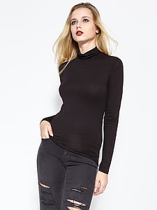 woman wearing black long-sleeved shirt and distress black denim bottoms thumbnail