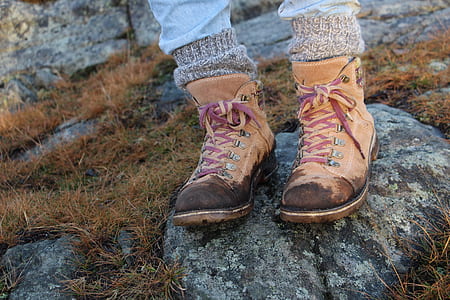 person wearing pair of hiking boots on rock thumbnail
