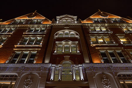 Upward View of Brown Building at Night thumbnail
