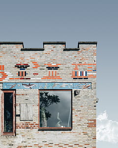 gray and orange brick building under gray sky during daytime photogrpahy thumbnail