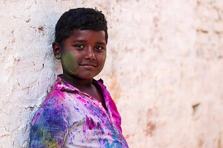 boy in white shirt covered in paint leaning on wall thumbnail