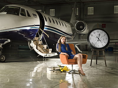 woman in blue long-sleeved dress sitting on armchair thumbnail