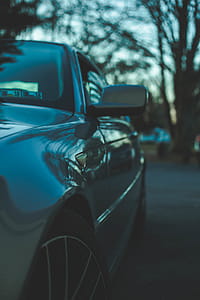 Selective Focus Photography of Gray Vehicle Parked Under Shade of Tree thumbnail