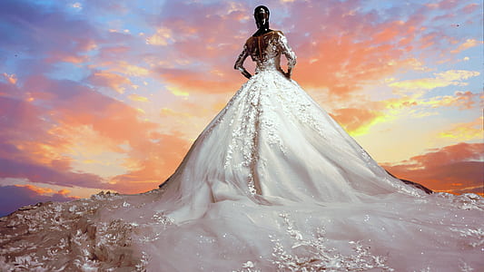 woman with white ball water gown under yellow sky during daytime time lapse photo thumbnail