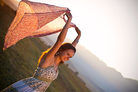 woman wearing blue and white dress holding brown scarf thumbnail