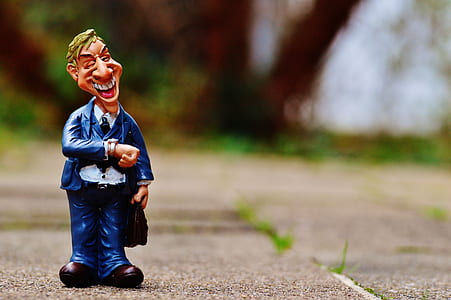 selective focus photography of man in black suit figurine thumbnail