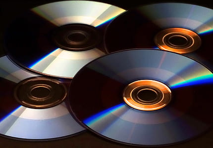 several compact discs on top of table thumbnail