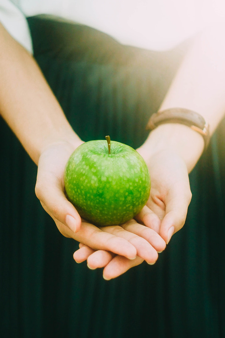 green apple on man hand