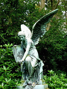 statue of angel holding rectangular board sitting on brick thumbnail