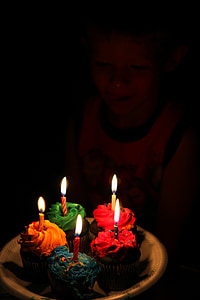 boy holding five cupcakes with candles thumbnail