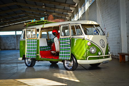 motor scooter inside green and white Volkswagen T1 parked inside building thumbnail