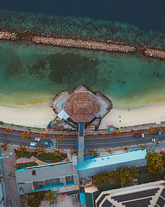 aerial photography of building near beach on side of road thumbnail