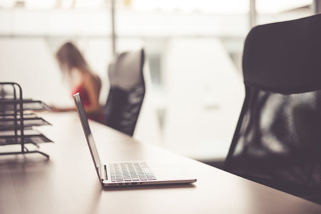Laptop on Wooden Desk in Office Open Space thumbnail