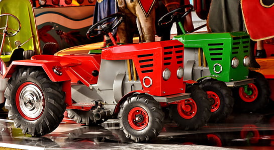 two red and green riding mowers thumbnail