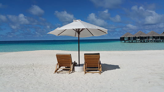 patio umbrella with two adirondaks facing towards sea thumbnail