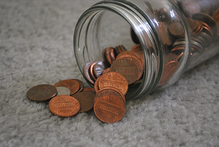 bronze coins in clear glass jar thumbnail
