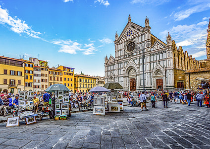 people walking outside beige cathedral under blue sky during daytime thumbnail