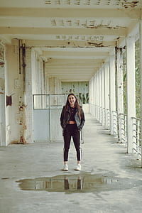 brown haired woman in black jacket standing in middle smiling thumbnail