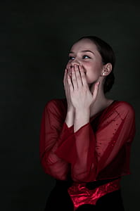 smiling woman wearing red tops while covering its mouth thumbnail