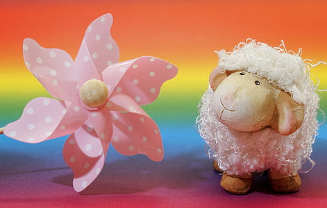 sheep plush toy beside pink and white polka-dotted floral accessory thumbnail