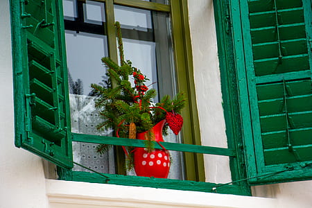 artificial red petaled flower with red vase on window thumbnail