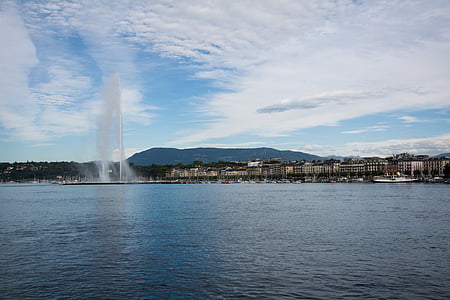 fountain near buildings and body of water thumbnail