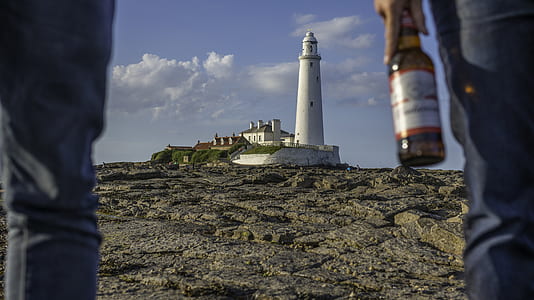 white lighthouse under cloudy blue sky during daytime thumbnail