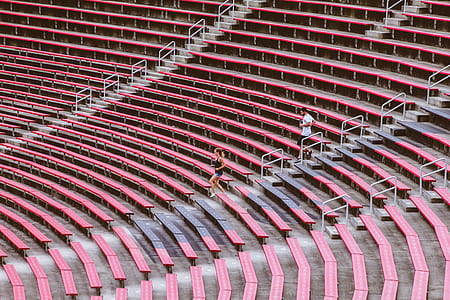 man and woman running down stadium thumbnail