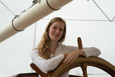 woman standing in-front of ship wheel thumbnail
