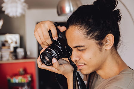 man holding DSLR camera thumbnail