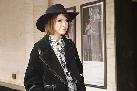 woman in black coat walking beside Romeo and Juliet poster thumbnail