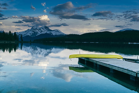 beach dock on body of water with canoe thumbnail