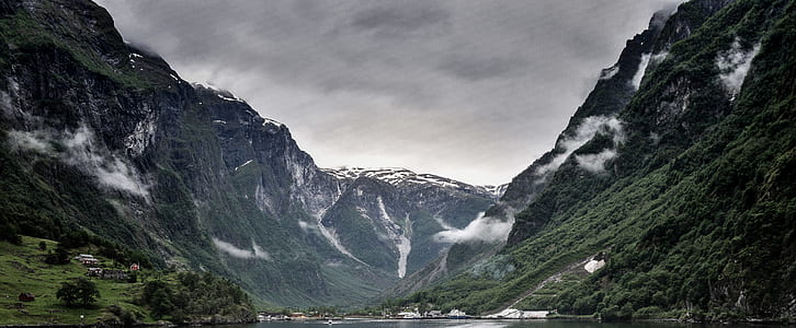 landscape photography green covered mountain under cloudy sky thumbnail