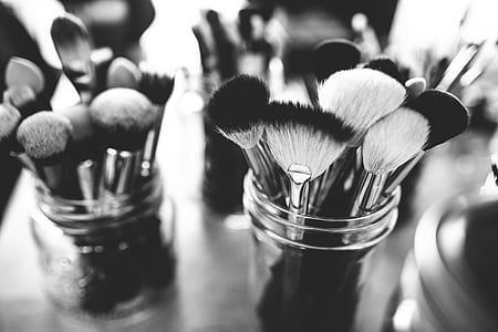 grayscale photo of makeup brushes on Mason jars thumbnail