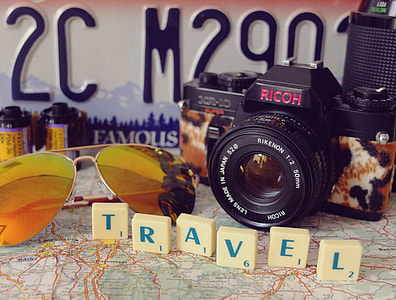black Ricoh DSLR camera and aviator sunglasses thumbnail