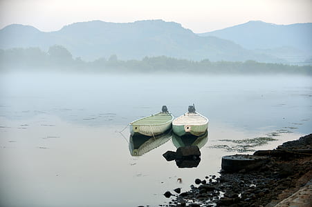 white outboard boats near shore thumbnail