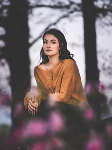 woman resting her arms on fence thumbnail