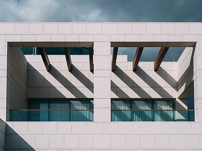 concrete building under clouds thumbnail