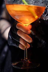 person holding cocktail glass thumbnail