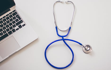 blue stethoscope on table near laptop thumbnail