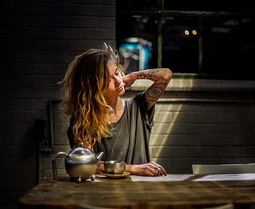 woman beside table reaching her back thumbnail