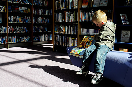 boy wearing jacket and jeans holding book thumbnail