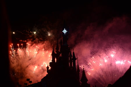 silhouette castle with lighted fireworks at night thumbnail