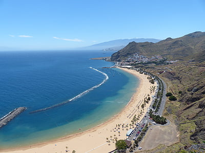 aerial view of shoreline beside mountain thumbnail